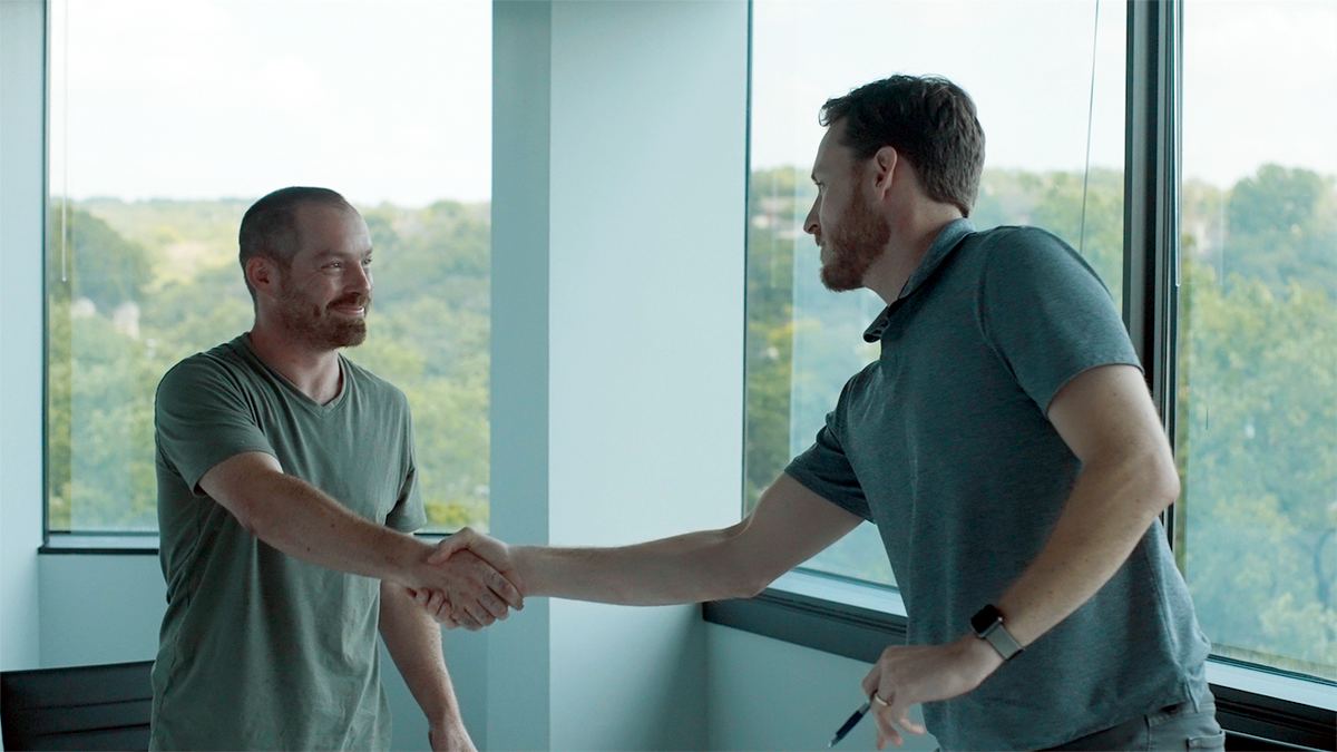 A Zinda Law Group attorney shaking hands with a client