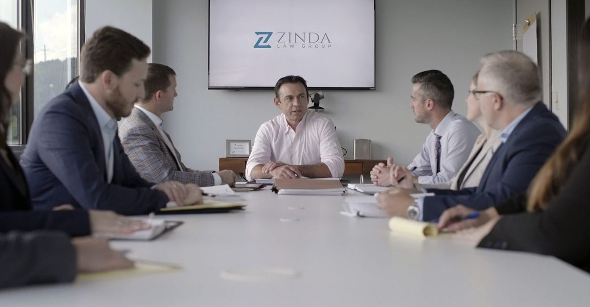 Jack Zinda leading a team meeting at Zinda Law Group